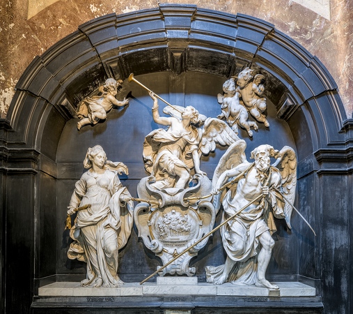 Stone wall sculpture depicting human figures and angels.